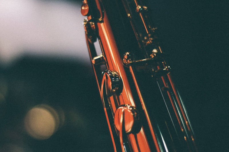 wood - material, indoors, string, saxophone, selective focus, musical instrument, musical equipment, wind instrument, metal, string instrument, still life
