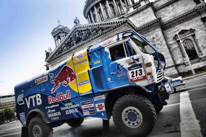 transportation, text, motor vehicle, street, day, architecture, building exterior, city, KAMAZ, western script, rally, white, 2K, blue, outdoors, communication