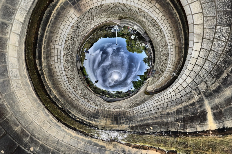 water, directly below, street, sky, architecture, travel, tiles, wheel, built structure, building, outdoors, low angle view, geometric shape, lifestyles