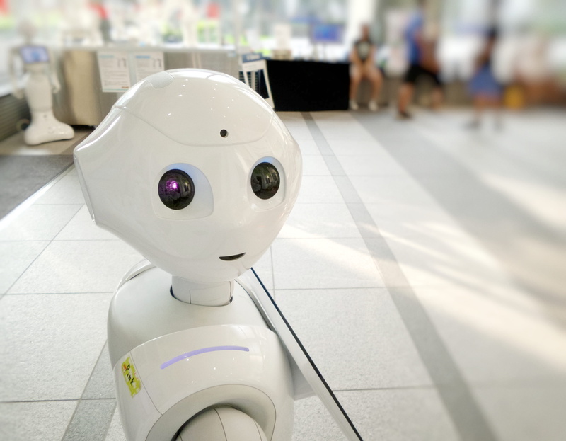 tiled floor, eye, incidental people, white, android, human representation, smile, head, face, ai, plastic, table, mascot, close-up, day, sculpture, technology