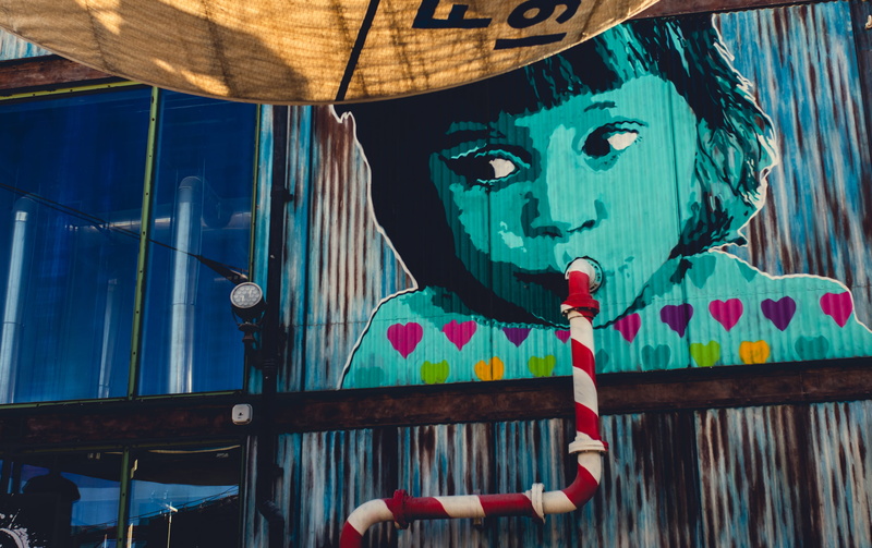 sipping, one person, men, artistic, heart, lifestyles, wall art, front view, looking, design, travel, young adult, color, street art, graffiti, artsy, colourful