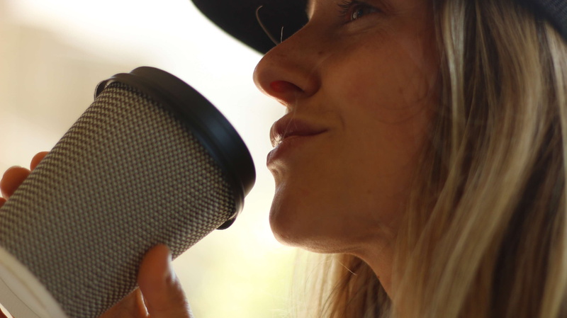 close-up, cup, headshot, music, side view, beautiful woman, pretty, takeout, adult, coffee to go, indoors, drinking, woman, mouth open, smiling, microphone