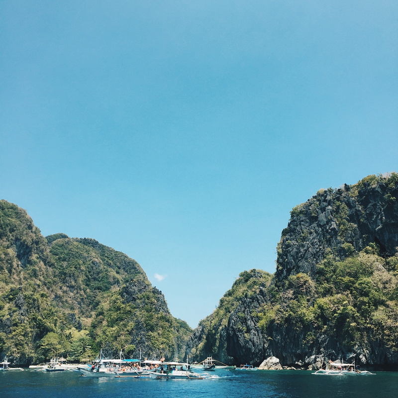 beauty in nature, asia, trees, water, day, near, scenics - nature, boat, solid, tropical, rock formation, lagoon, seashore, el nido, island, vacation, copy space