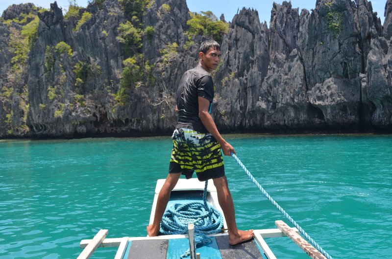 rock, full length, shorts, sea, lifestyles, nature, philippines, one person, casual clothing, leisure activity, rock - object, lagoon, boat, young adult