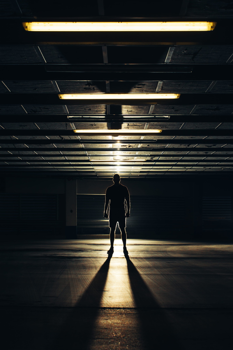 parking lot, leisure activity, robber, creepy, architecture, leading line, standing, full length, person, built structure, gate, real people, tunnel, silhouette