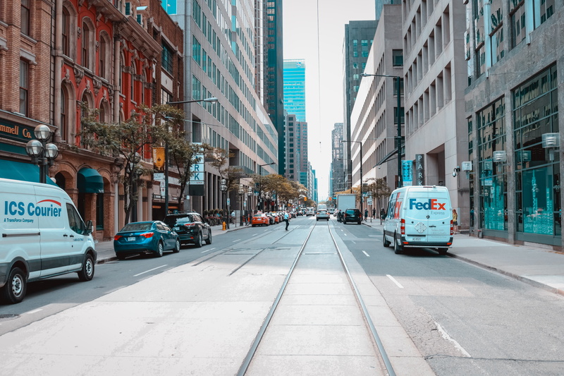 city life, cars, direction, motor vehicle, incidental people, residential district, near, hospital, diminishing perspective, tram tracks, building, vehicle
