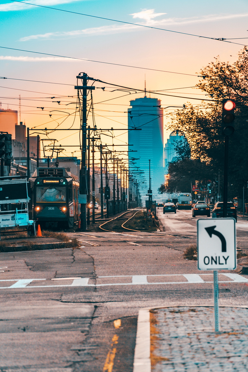 road, tree, power supply, road sign, outdoors, nature, motor vehicle, railway, trolley, gray, direction, united states, streetcar, tram, no people, vehicle