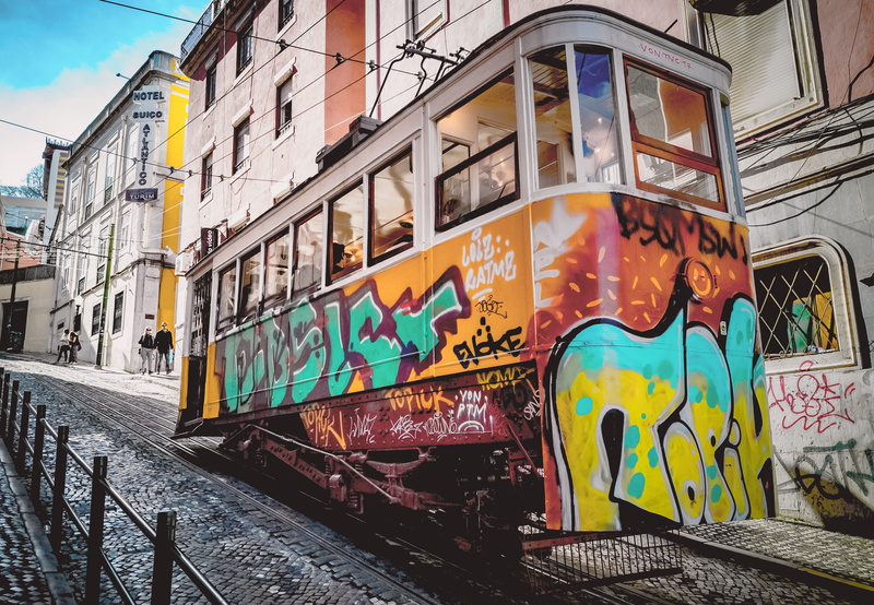 mode of transportation, yellow, orange, blue, transportation, tram, going up, no people, architecture, rail transportation, street, commuter, track, commuting