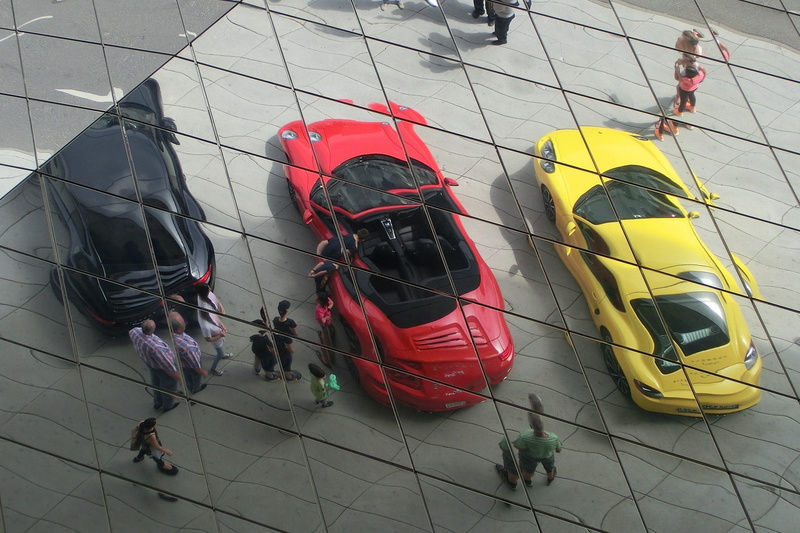 indoors, zuffenhausen, mode of transportation, helmet, high angle view, group, adventure, rope, day, german flag, stuttgart, group of people, porsche museum