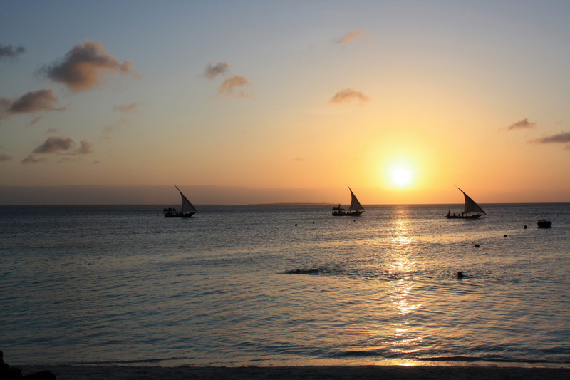 nature, scenics - nature, mode of transportation, the coast, sky, no people, horizon, sailboat, sun, orange color, transportation, horizon over water, zanzibar
