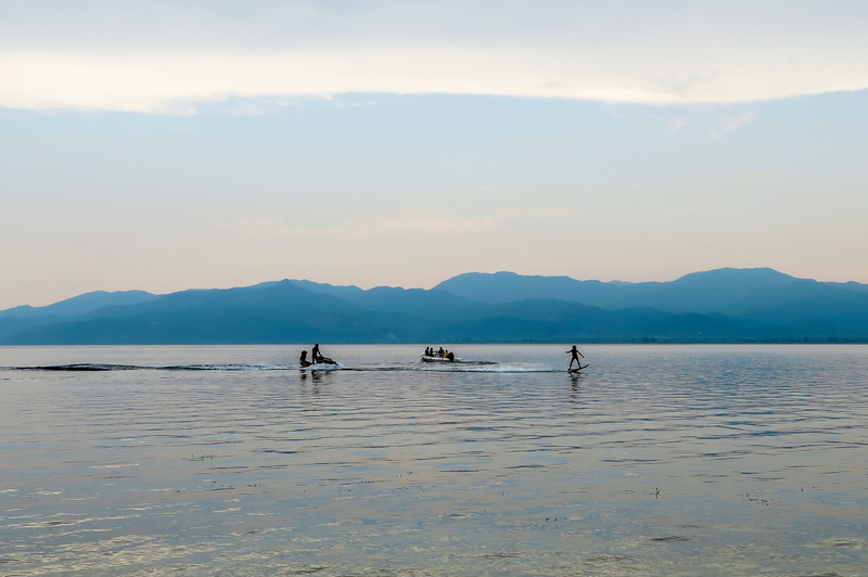 clouds, scenics, group, sky, tranquil scene, cloud - sky, lifestyles, tranquility, person, middle, blue, craft, men, sea, different, beauty in nature, surfboard