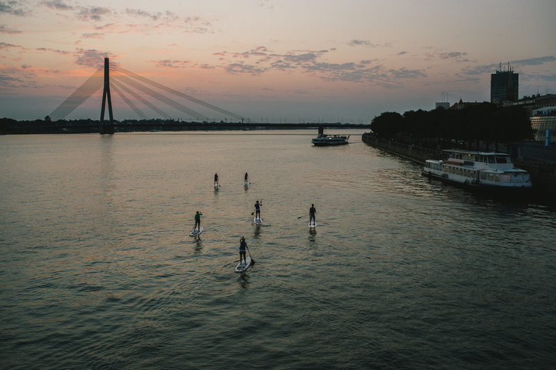bridge, beauty in nature, lifestyle, paddleboard, reflection, built structure, group of people, fitness, transportation, sky, sport, surf, sunrise, activity