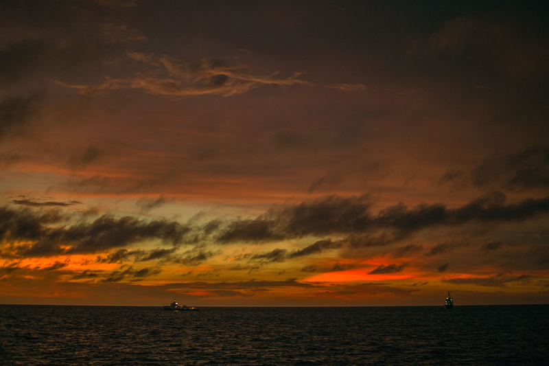 waterfront, orange color, beach, outdoors, tranquil scene, land, boat, sea, sailing, 5K, night time, cloud, open sea, nature, water, horizon over water
