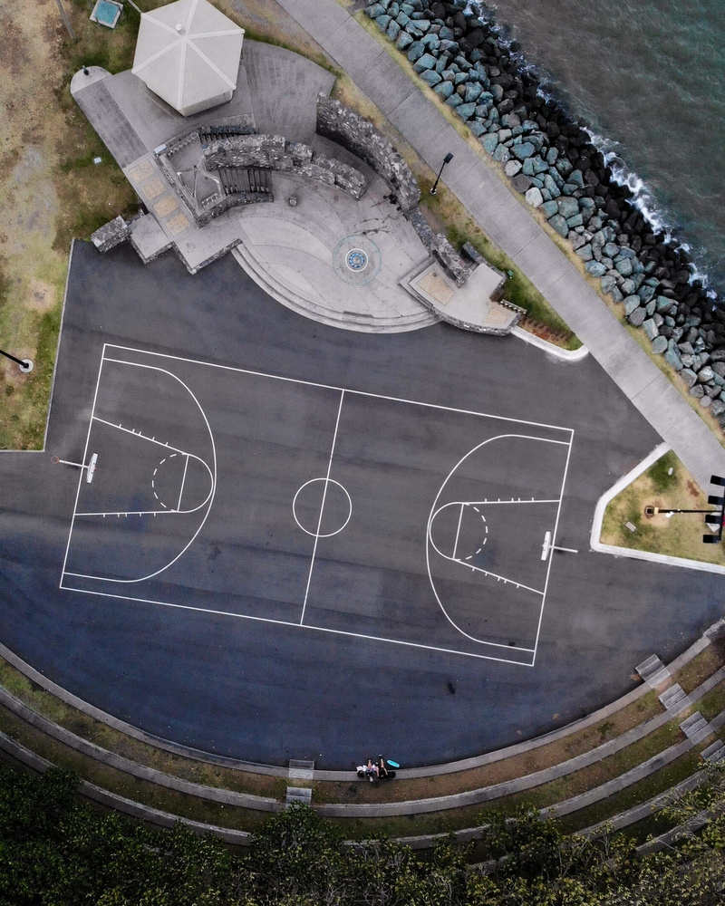 tarmac, high angle view, outdoors, asphalt, soccer field, aerial view, geometric shape, sport, intersection, empty, soccer, road, basketball, nature, circle