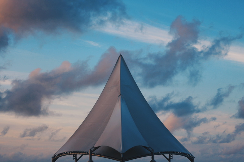 sunset, presidential jetty, sky, outdoors, day, built structure, high section, flag, cloud - sky, triangle shape, no people, blue, building exterior, focus on foreground