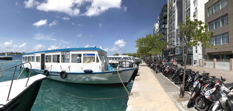 city, incidental people, malé, land vehicle, canal, day, male, sky, travel, built structure, transportation, mode of transportation, maldives, skyline