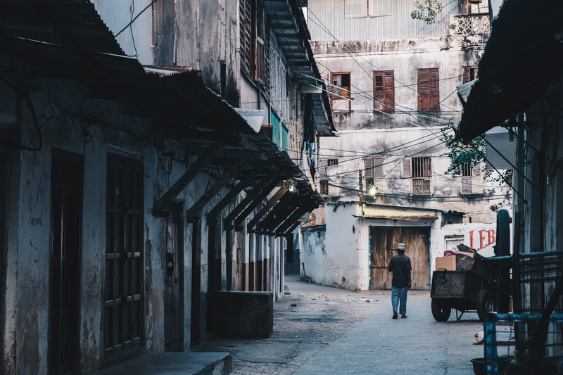 full length, concrete, brown, lifestyles, buildings, day, daytime, cart, leisure activity, 5K, street, one person, cityscape, slum, city, outdoors, unguja