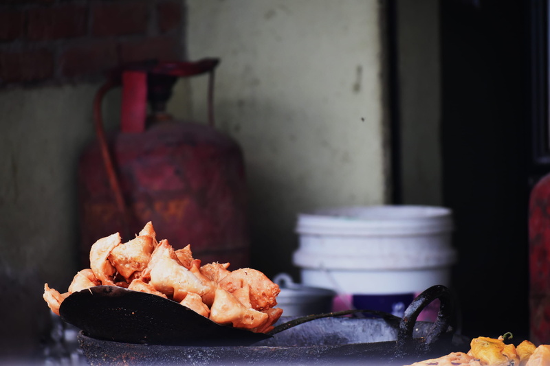 food and drink, deepfry, tray, selective focus, fritters, samosa, indoors, foodie, indian culture, 2K, close-up, plate, foodlover, asian food, fun, new delhi