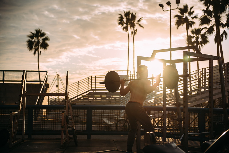 palm tree, cloud - sky, architecture, sun, tree, sport, health, sunset, sky, leisure, carribean, water, full length, equipments, real people, nature, railing