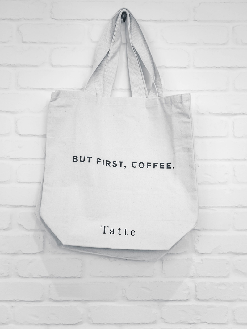 white background, indoors, close-up, accessories, no people, black and white, shopping bag, text, wall - building feature, sign, western script, bw, paper