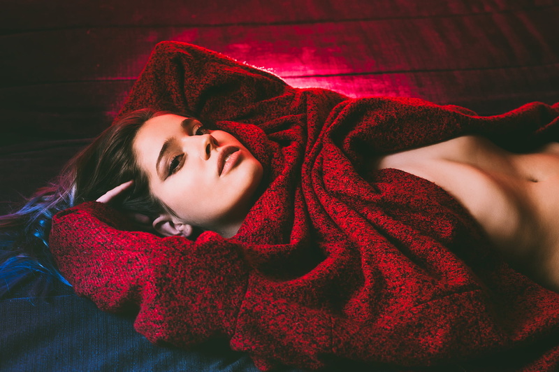 young adult, warm clothing, clothing, contemplation, lying on back, headshot, beautiful woman, indoors, on the floor, sweater, relaxation, lying down, model