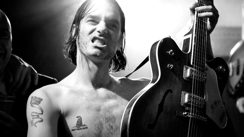 front view, shirtless, real people, music, arts culture and entertainment, tattoo, s, portrait, musician, show, one person, teeth, musical instrument, lifestyles