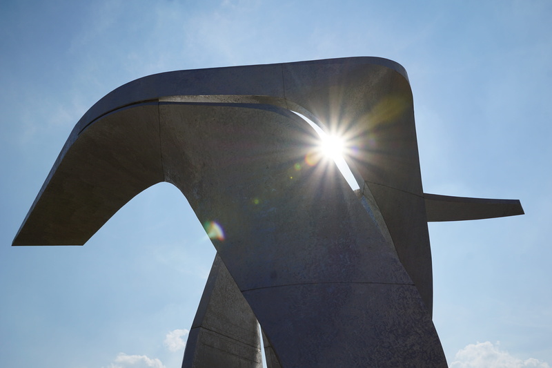 outdoors, modern, sunlight, sculpture, worlds fair, expo, sky, low angle view, lens flare, art and craft, sunbeam, back lit, sunny, travel destinations