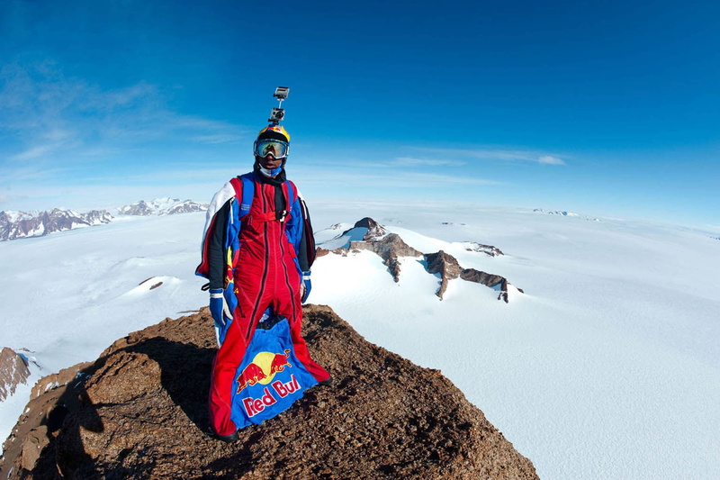 camera, shadows, warm clothing, full length, 1080P, portrait, mountain range, base jumping, pilot, scenics - nature, outdoors, one person, mountain peak