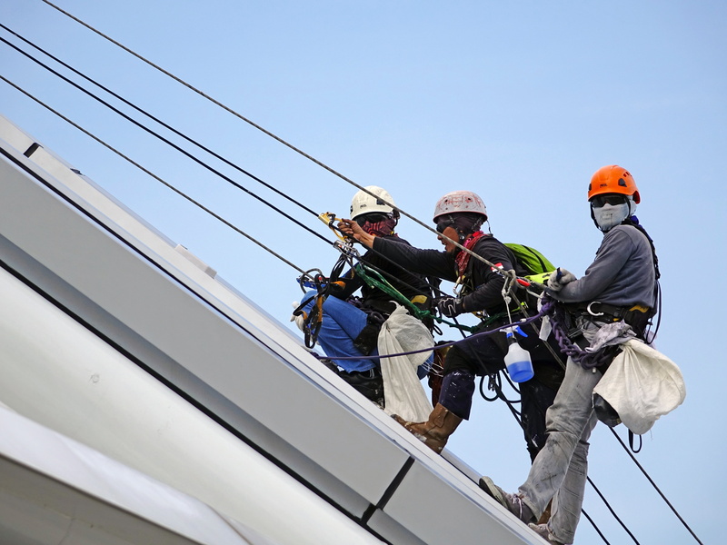 mature men, protection, sky, safety harness, rope, group of people, three, climbing, carabiner, architecture, outdoors, cooperation, challenge, working