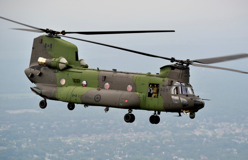 clear sky, armed forces, helicopter, mid-air, mode of transportation, weapon, propeller, CH-47F, canadian, transport, single object, day, gray, plane, on the move