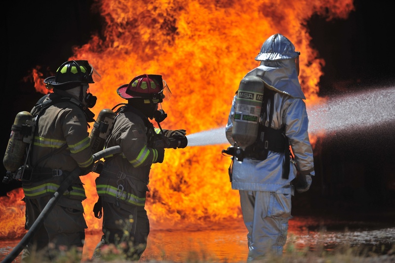 emergency services occupation, outdoors, burning, portrait, rescue, firefighters, occupation, healthcare and medicine, fire, helmet, water, smoke, fire - natural phenomenon