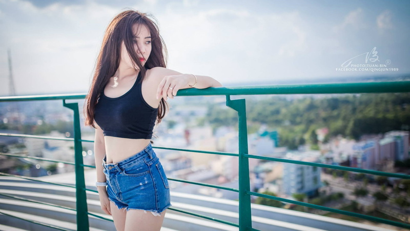 three quarter length, hairstyle, beauty, beautiful woman, real people, model, clothing, dark hair, long hair, railing, teenager, outdoors, focus on foreground