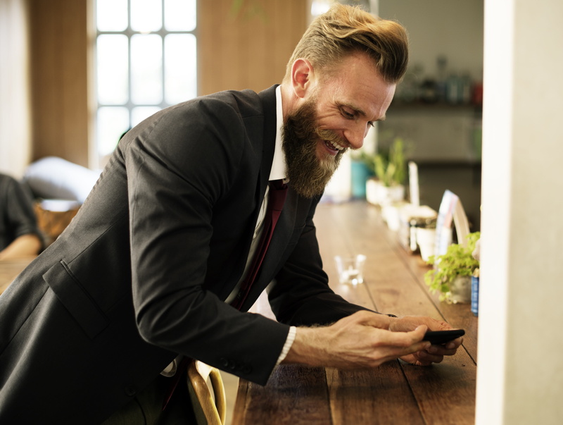 brown, indoors, leisure, person, small business, focus on foreground, real people, wooden table, corporate, side view, mobile phone, man in black, casual Clothing