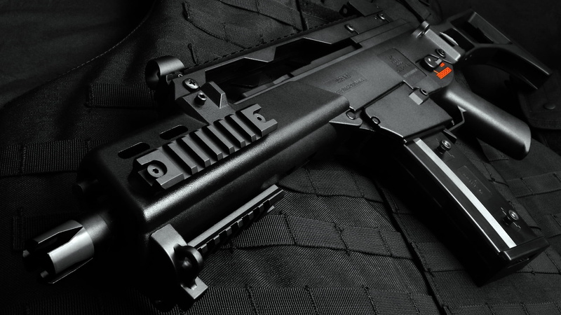 rifle, close-up, no people, indoors, aggression, black color, 1080P, table, handgun, safety, black, sign, violence, text, gun, assault, still life, machine
