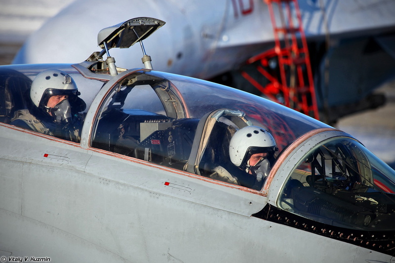 military, airplane, mode of transportation, helmet, uniform, day, stationary, close-up, incidental people, cockpit, land vehicle, aircraft, outdoors, fighter plane