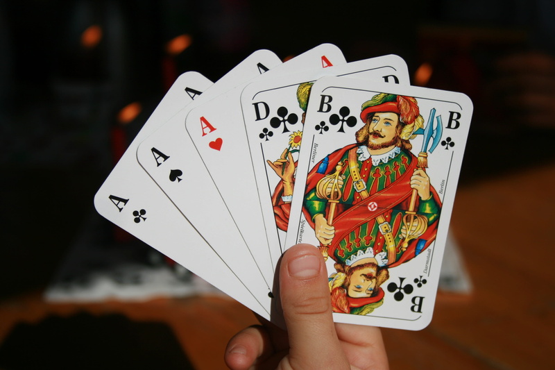 real people, playing Cards, holding, Card Game, one person, focus on foreground, human Hand, gambling, person, arts culture and entertainment, queen Card