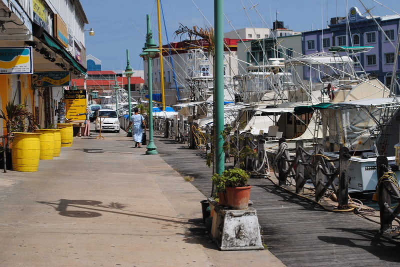women, building, nature, mode of transportation, day, shops, real people, direction, water, bridgetown, woman, outdoors, street, nautical vessel, sunlight