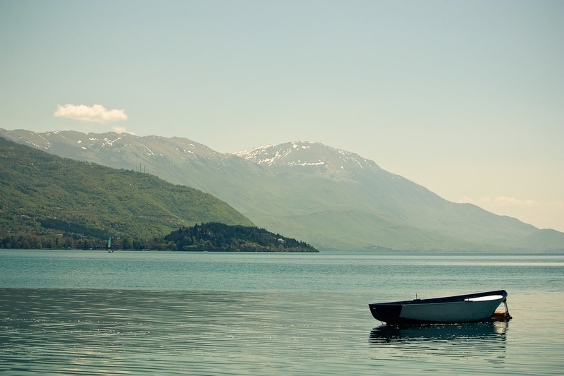 gray, mountain range, outdoors, boat, mountain, tranquil scene, sky, travel, beauty in nature, anchored, lake, scenics - nature, waterfront, tranquility