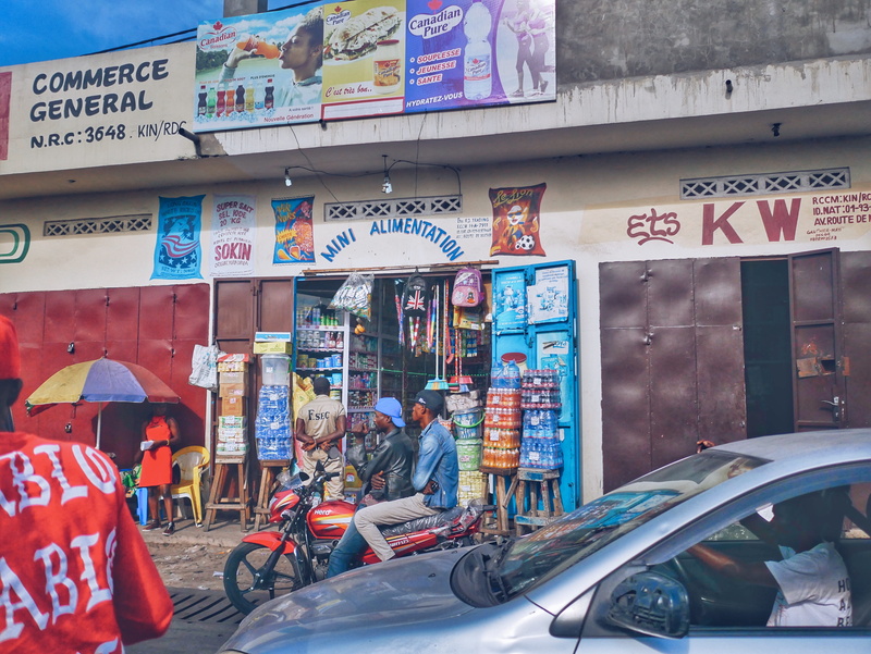 people, rdc, script, day, street photography, motor vehicle, zaire, real people, retail, building exterior, outdoors, africans, communication, transportation