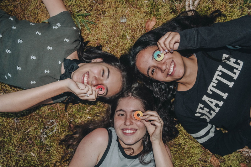 people, cushion, afro hairstyle, bonding, women, outdoors, high angle view, crowd, home decor, childhood, positive emotion, clothing, smile, flora, group of people