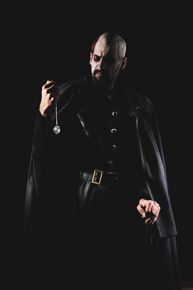 theatery, weapon, looking away, photo, mid adult men, devil, young adult, males, men, waist up, black background, evil, hand, holding, adult, man, godox