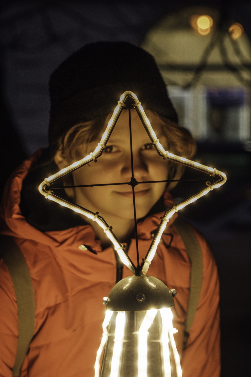 headshot, vigil, spooky, human, close-up, trophy, accessory, illuminated, focus on foreground, hanging, led, indoors, sphere, musical instrument, finger