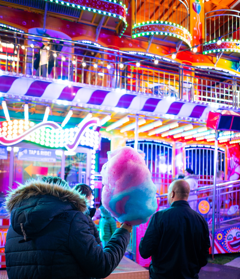 cotton, adult, indoors, pink, person, holding, overcoat, festival, group of people, illuminated, fun, theme park, warm clothing, built structure, leisure activity