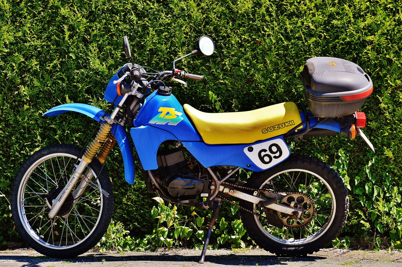 motorbike, outdoors, yellow, vehicle, day, colors, cyclist, no people, land vehicle, enduro, grass, model, ts, sunlight, nature, scooter, blue, bicycle