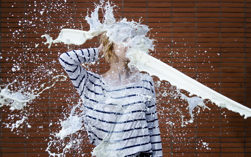 built structure, lifestyles, brick, arms raised, one person, architecture, women, milk, leisure activity, white color, brick wall, nature, splashing, young adult