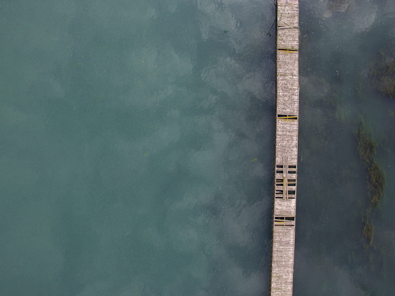 tranquility, nature, renewable energy, texture, no people, pier, reflection, lake, river, concrete, outdoors, high angle view, water, fuel and power generation