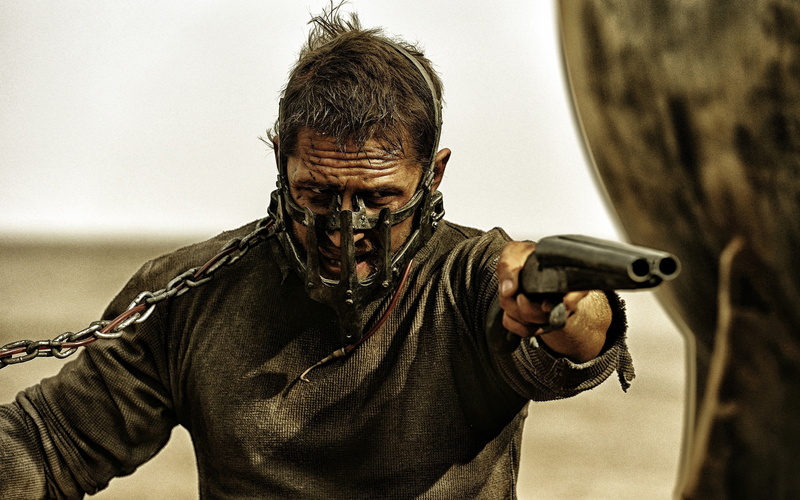 holding, headshot, gun, portrait, focus on foreground, adult, males, communication, outdoors, weapon, 2K, one person, close-up, day, emotion, mad max fury road mad max tom hardy shotgun
