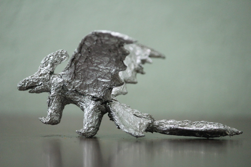 indoors, dragon, night fury, focus on foreground, selective focus, gray, sculpture, animal representation, silver colored, metal, studio shot, nature, toothless