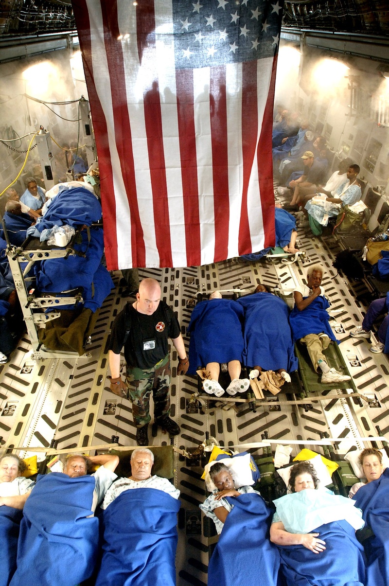 real people, 1080P, large group of people, adult, patriotism, city, uniform, low angle view, building exterior, plane, lifestyles, air force, group of people