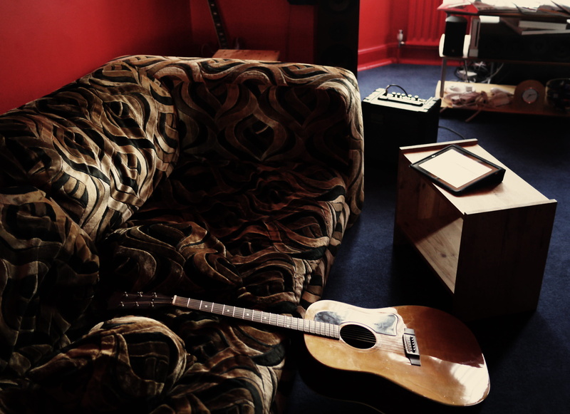 couch, indoors, retro, table, leather, sofa, carpet, arts culture and entertainment, red, leaning, skill, large group of objects, classic, craft, instrument